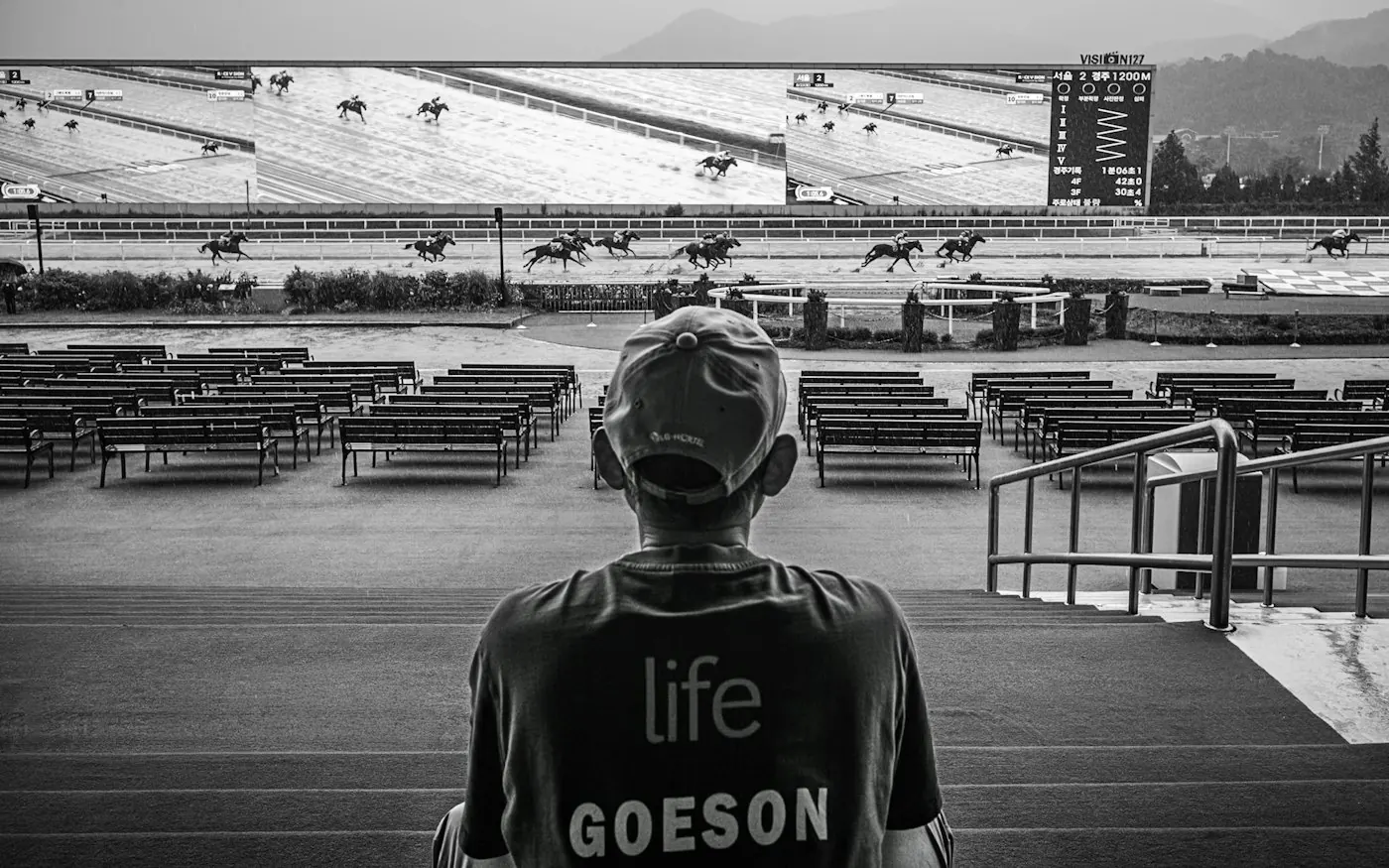 Spectator watching a race on a big screen